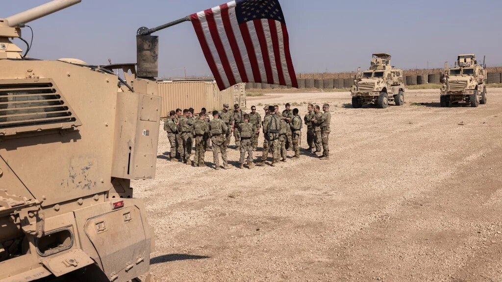 US army soldiers prepare to go out on patrol from a remote combat outpost on 25 May 2021 in northeastern Syria (AFP)