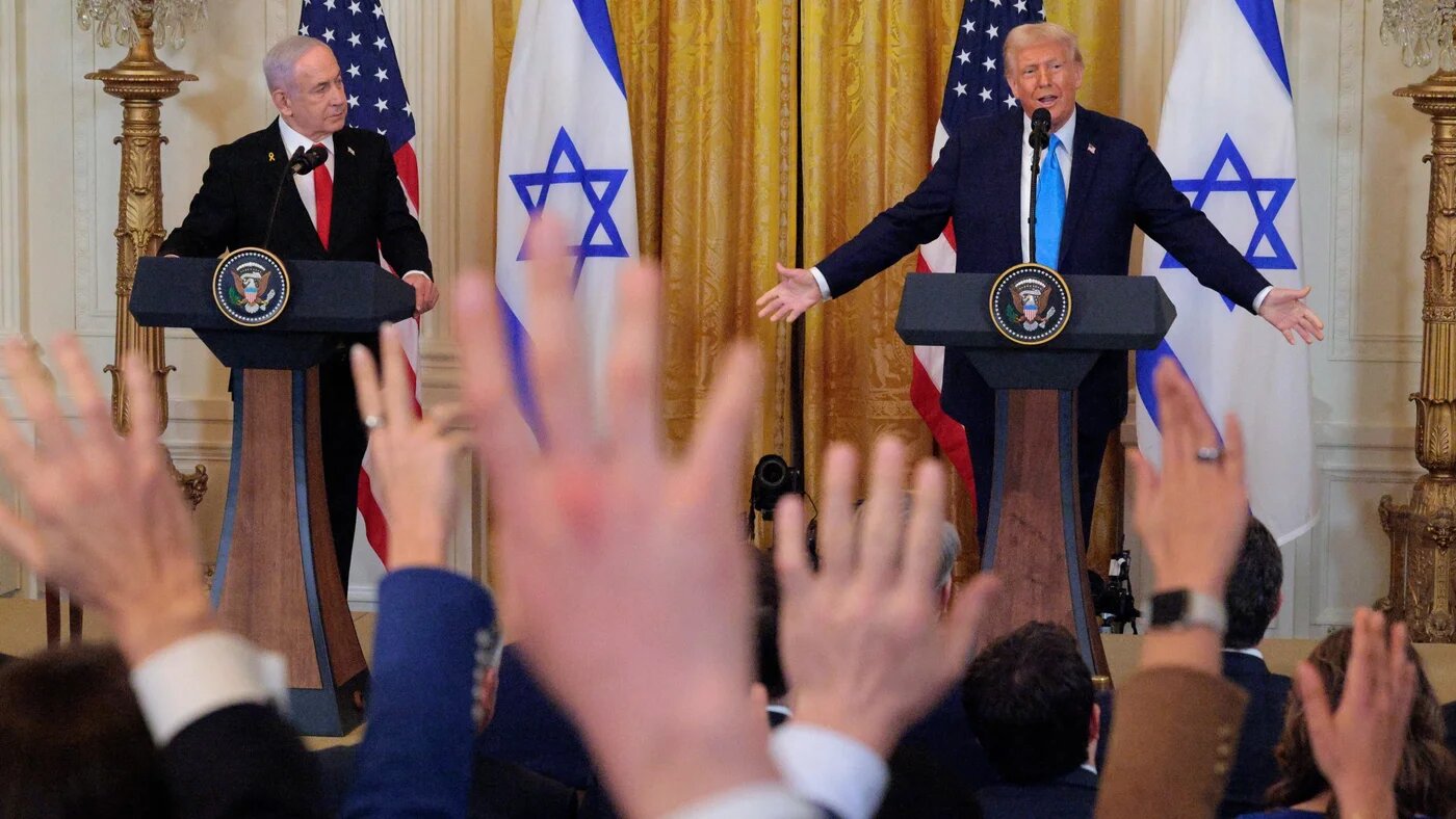 Reporters attempt to get the attention of US President Donald Trump as he and Israeli Prime Minister Benjamin Netanyahu hold a joint news conference in the White House on 4 February 2025 (Chip Somodevilla/Getty Images/AFP)