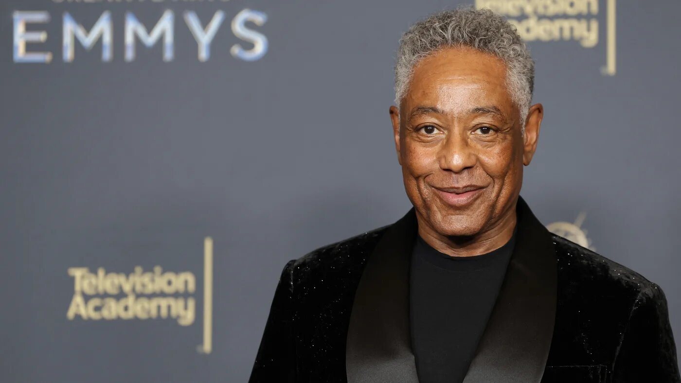 Giancarlo Esposito wearing a black tuxedo and posing for photographs at the 2025 Emmy Awards