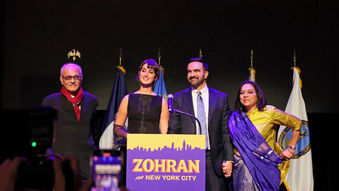 Democratic candidate for New York City mayor Zohran Mamdani stands with his wife, Rama Duwaji, and parents, filmmaker Mira Nair and scholar Mahmood Mamdani, during an election night rally in Brooklyn after winning the 2025 mayoral race, on 4 November 2025 (Michael M Santiago/Getty Images via AFP)