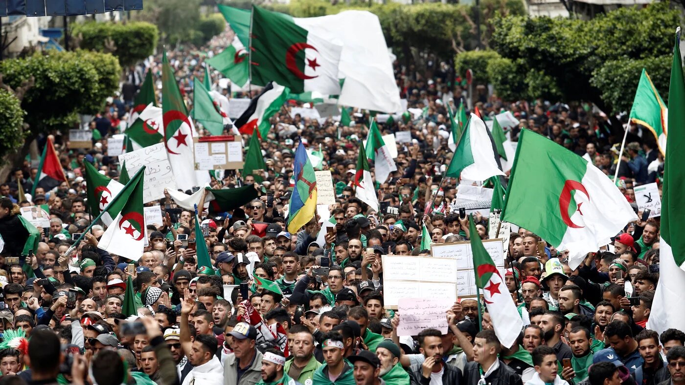 Protesters hold flags and banners in Algiers as they press demands for democratic change, April 19, 2019. 