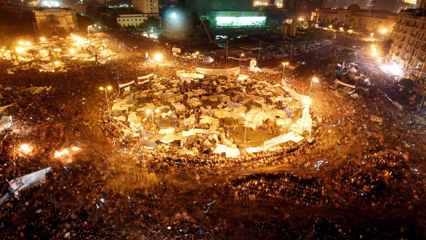 Egyptian protesters celebrate in Tahrir Square after the announcement of Hosni Mubarak's resignation in Cairo, Egypt, on 11 February 2011 (Abdallah Dalsh/Reuters)