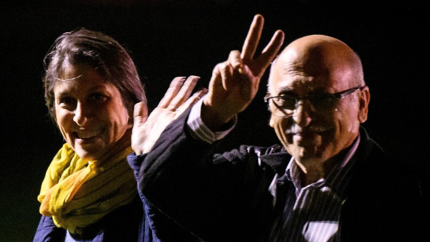 Nazanin Zaghari-Ratcliffe and Anoosheh Ashoori gesture after landing at RAF Brize Norton military airbase, in Britain, 17 March 2022 (Reuters)