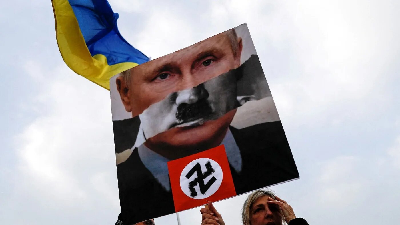 A protestor in Tel Aviv holds up a sign at a demonstration in support of Ukraine following Russia's invasion (Reuters)