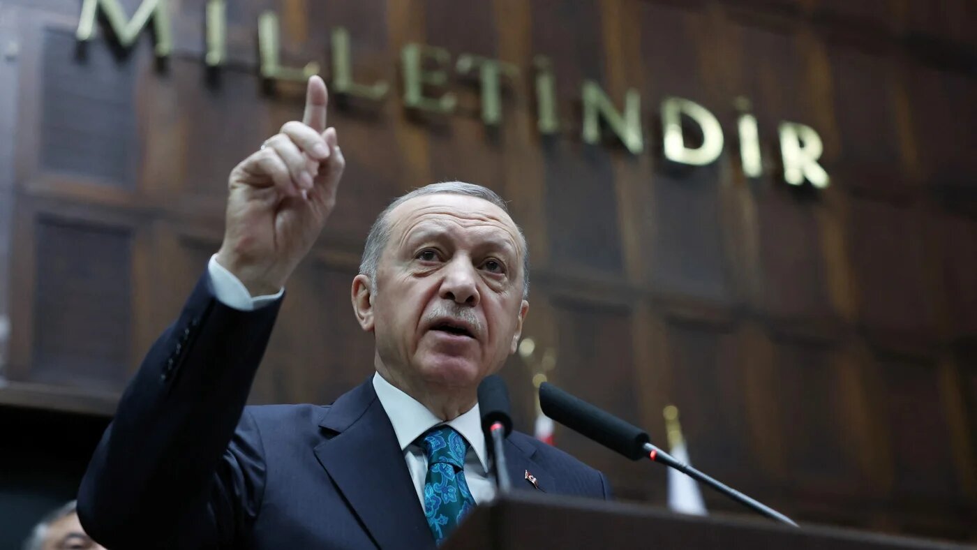 Turkish President Recep Tayyip Erdogan addresses members of his ruling AKP during a meeting at the parliament in Ankara, 29 March (Reuters)
