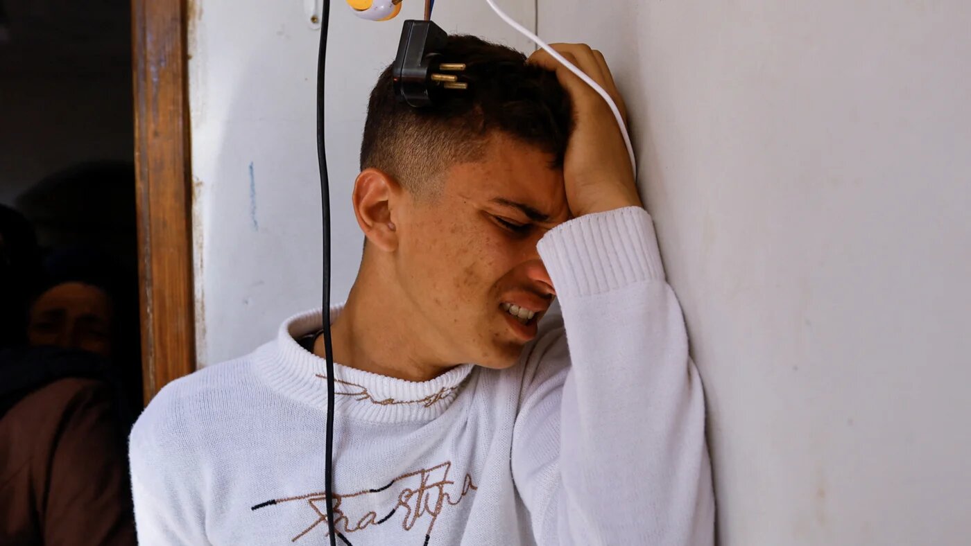 A mourner reacts during the funeral of a Palestinian killed in an Israeli strike in Khan Younis in the southern Gaza Strip 10 May 2023 (Reuters)