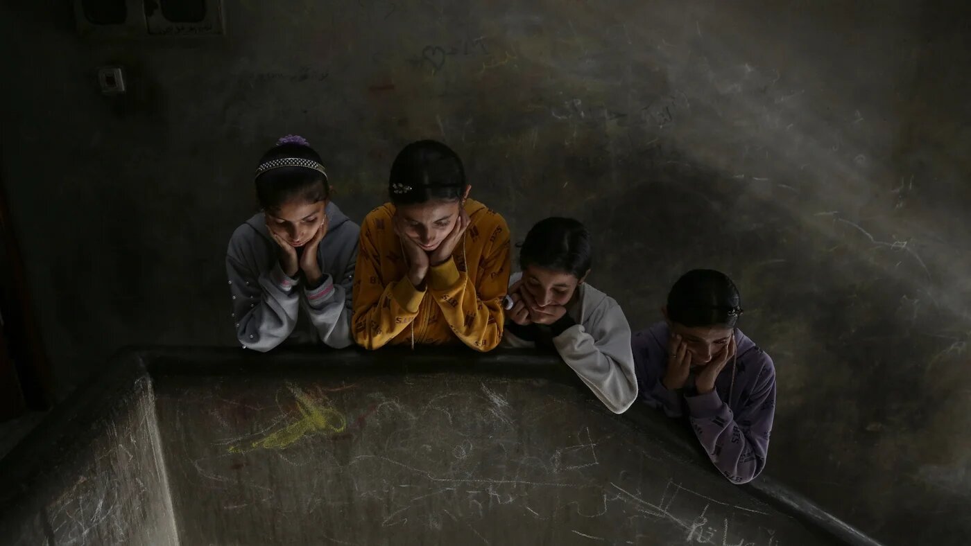 Children attend the funeral of a Palestinian killed in an Israeli strike, in Khan Younis, Gaza on 11 May 2023 (Reuters)