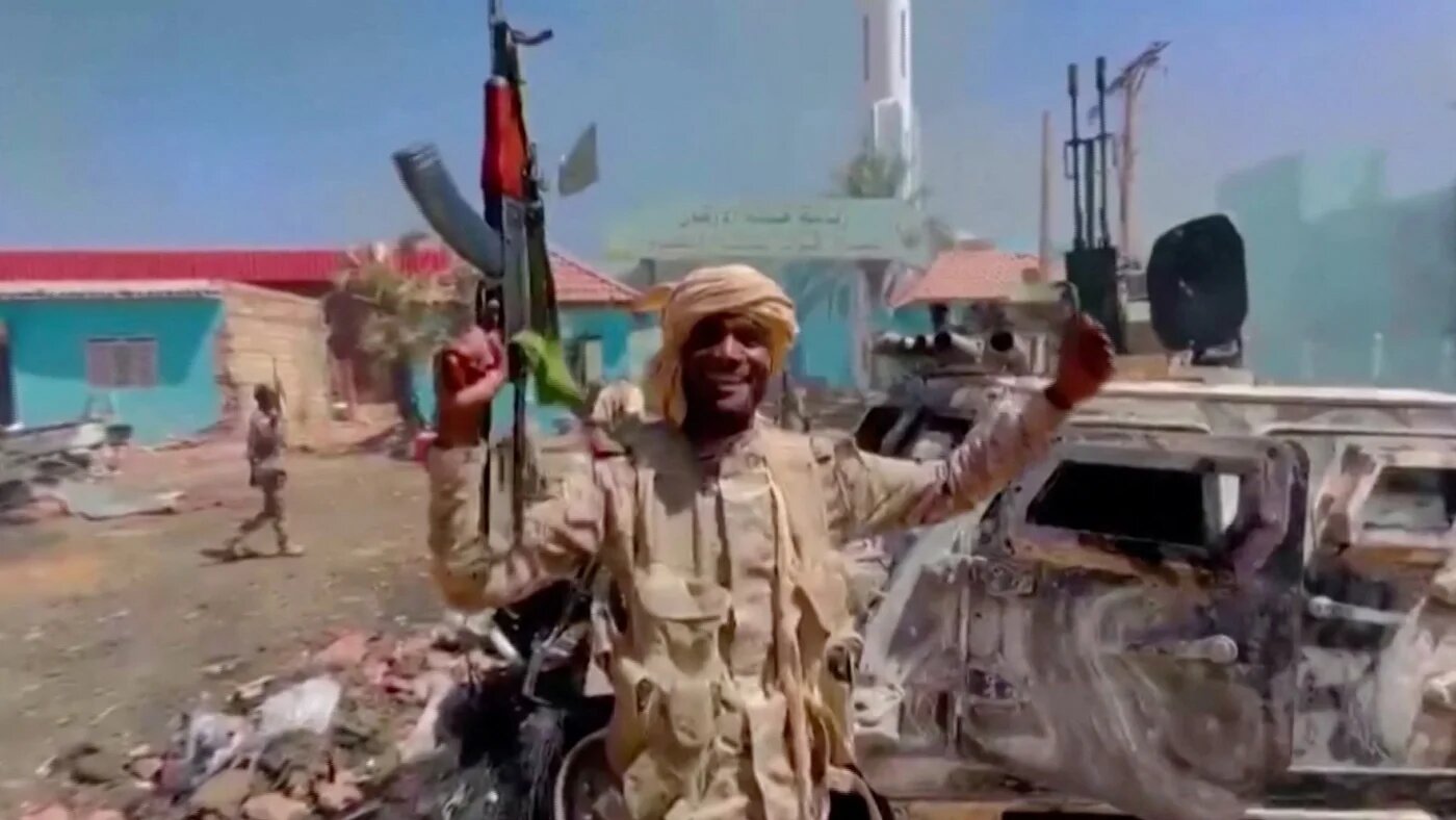 A member of the RSF forces walks around the destroyed Air Defence Forces command site in Khartoum on 14 June (Reuters)