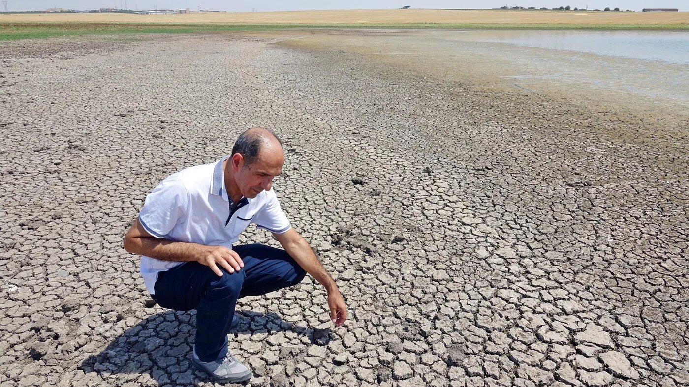 Cracked-mud surface seen at Kabakli lake, whose waters are withdrawn from the extreme heat, near the city of Diyarbakir in Turkey on 10 August 2023 (SOPA Images via Reuters)