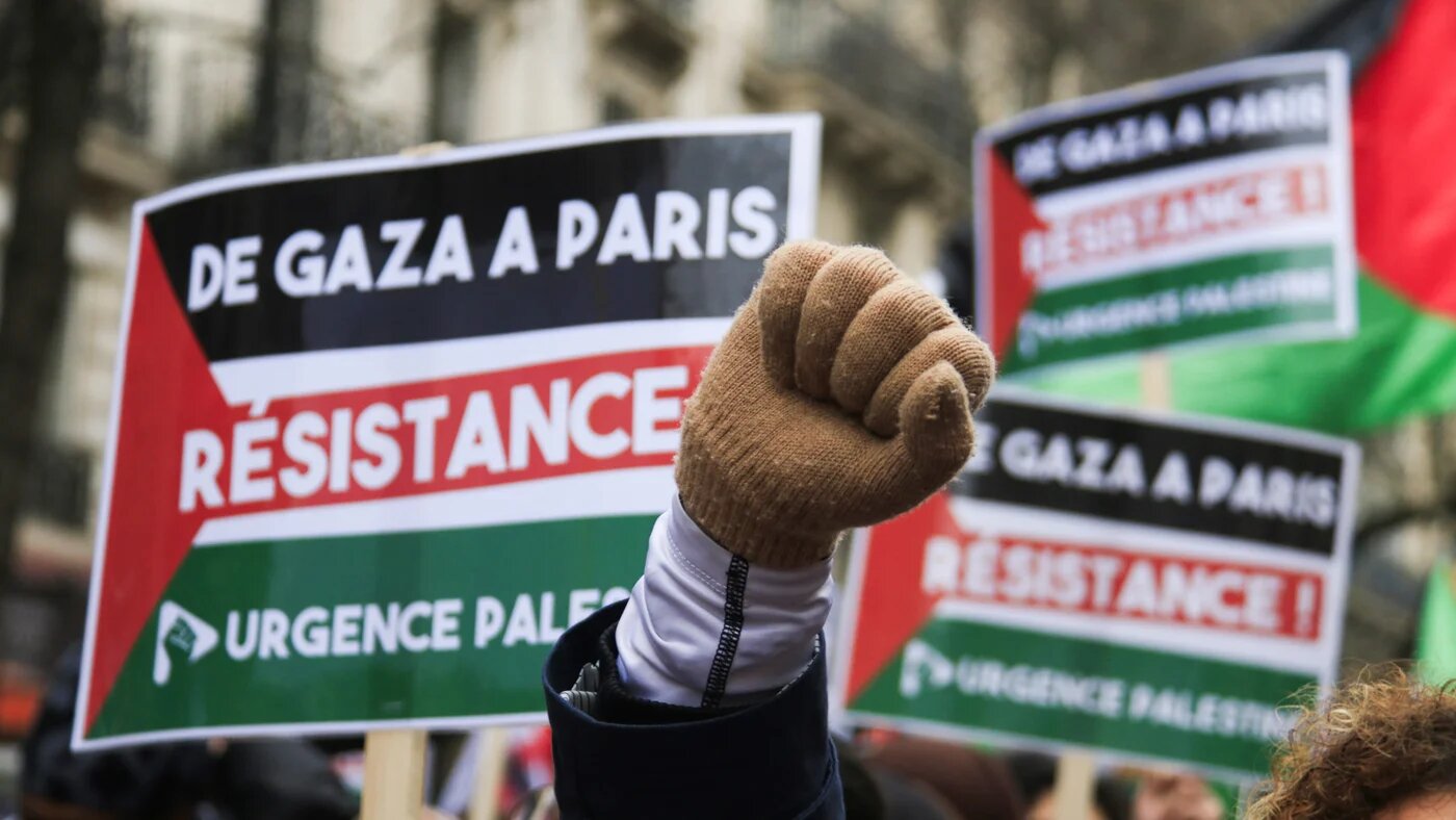 A protester raises her fist during a march in favour of a ceasefire in Gaza in the French capital Paris on 13 January 2024 (Quentin de Groeve/Hans Lucas via Reuters)