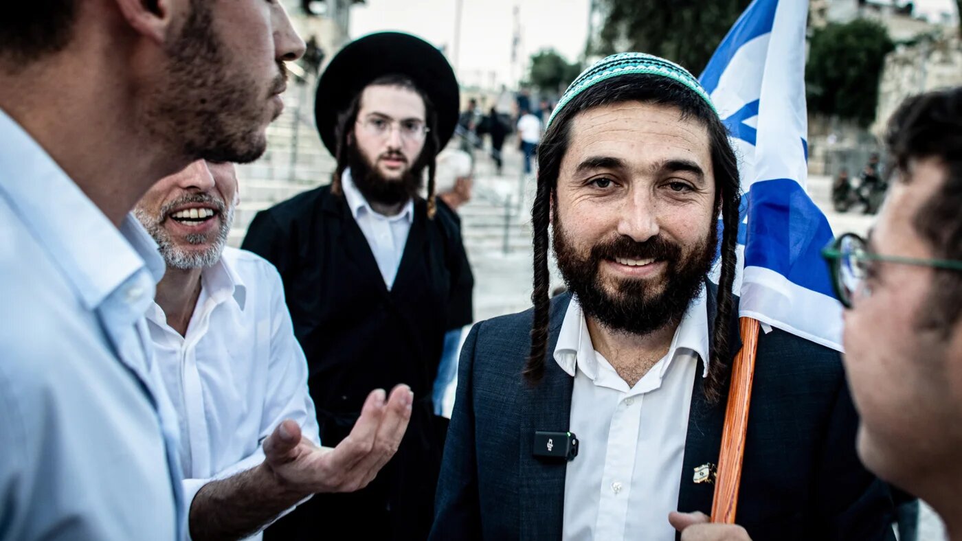 Israeli member of Knesset, Zvi Sukkot holds an Israeli flag outside Damascus gate in Jerusalem on 5 June 2024 (ZUMA Press Wire via Reuters)