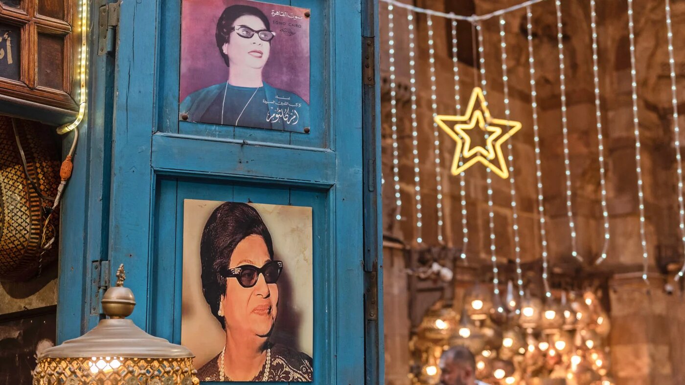 Portraits of Umm Kulthum, the Egyptian singer, songwriter and film actress who became an icon across the Middle East, are displayed in a cafe in Cairo on 2 July 2024 (John Wreford/SOPA Images via Reuters)