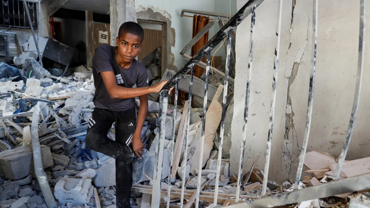 A Palestinian boy stands amidst the rubble at the site of an Israeli air strike in Tulkarm camp in theoccupied West Bank, 4 October 2024 (Reuters/Raneen Sawafta)