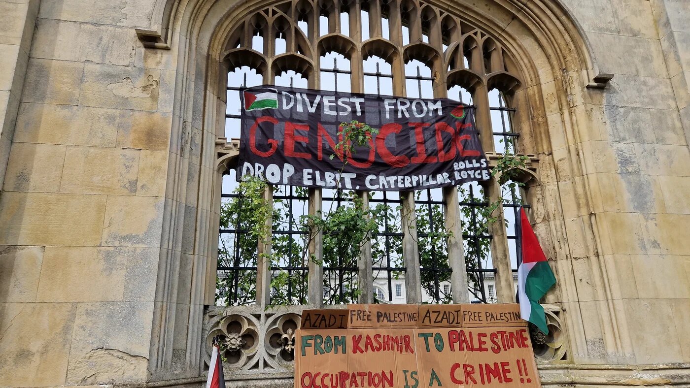 A banner calling for divestment at the student encampment for Gaza on Cambridge's iconic King's Parade