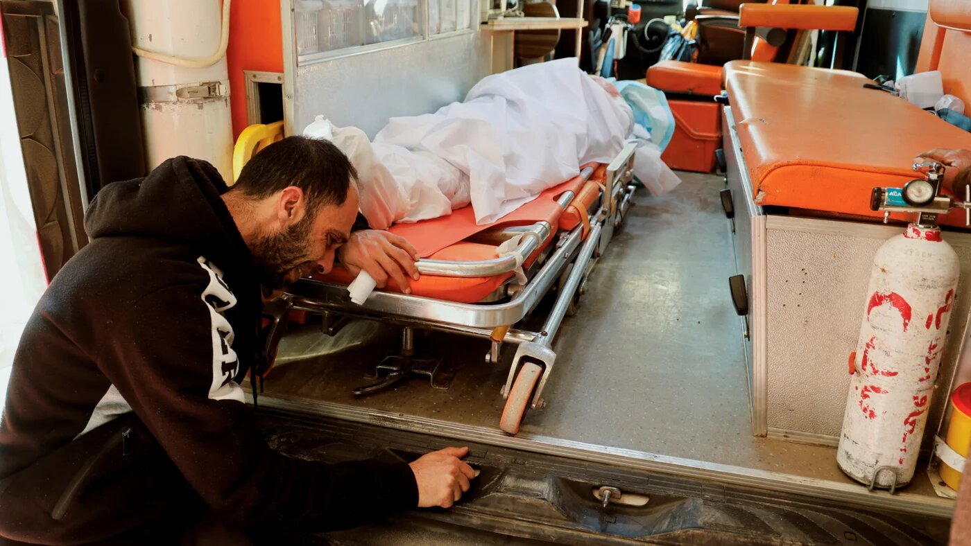 Palestinian Fadi Al-Saadi reacts next to the body of his brother Abdel-Wahab, who was killed in an Israeli raid, in Jenin, in the Israeli-occupied West Bank 21 January 2025 (Reuters/Raneen Sawafta)