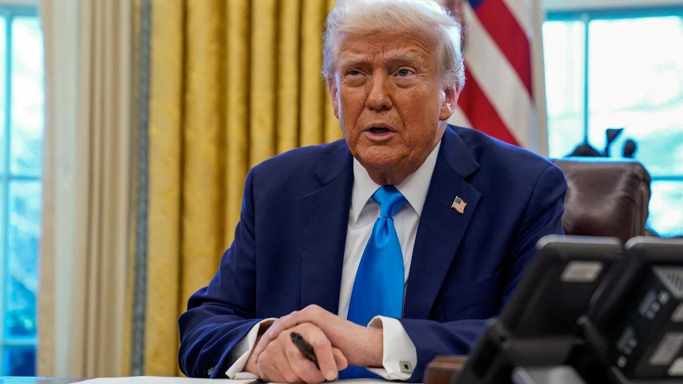 US President Donald Trump speaks as he signs documents in the Oval Office at the White House in Washington, US 4 February, 2022 (Elizabeth Frantz/Reuters)