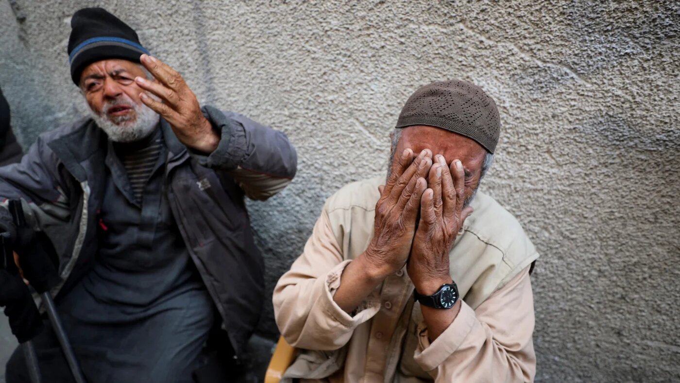 Palestinians react at the site of an Israeli strike on a residential building in Jabalia in the northern Gaza Strip on 18 March 2025 (Reuters/Mahmoud Issa)