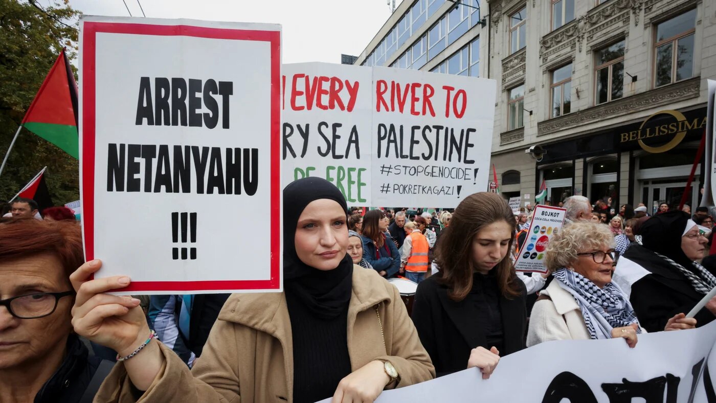 Protesters hold signs calling for the arrest of Israeli Prime Minister Benjamin Netanyahu during a Palestine solidarity protest in Sarajevo, Bosnia and Herzegovina, on 12 October 2025 (Amel Emric/Reuters)