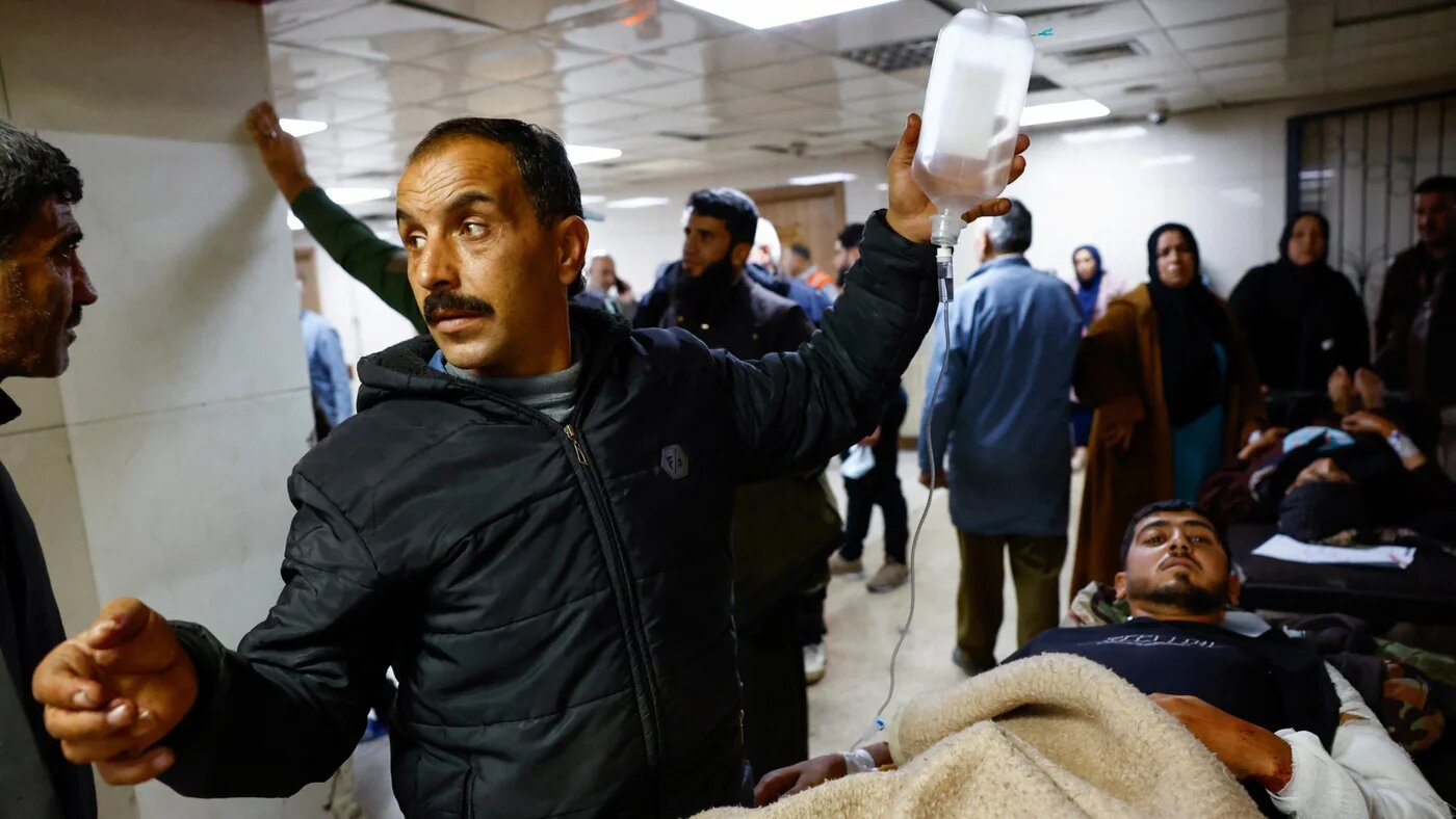 People gather near casualties inside a hospital, following an Israeli raid in the Beit Jinn area of southern Syria, 28 November 2025 (Reuters/Yamam al Shaar)