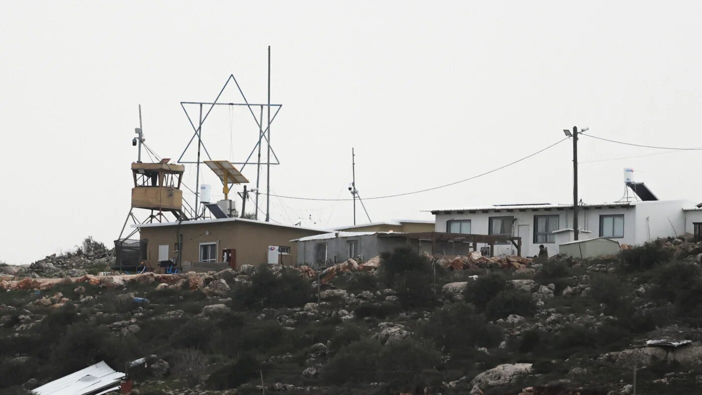 A large Star of David is mounted atop a building near a watchtower in a new Israeli settlement near Beita, close to Nablus, in the occupied West Bank, 9 February 2026 (Reuters/Ammar Awad)