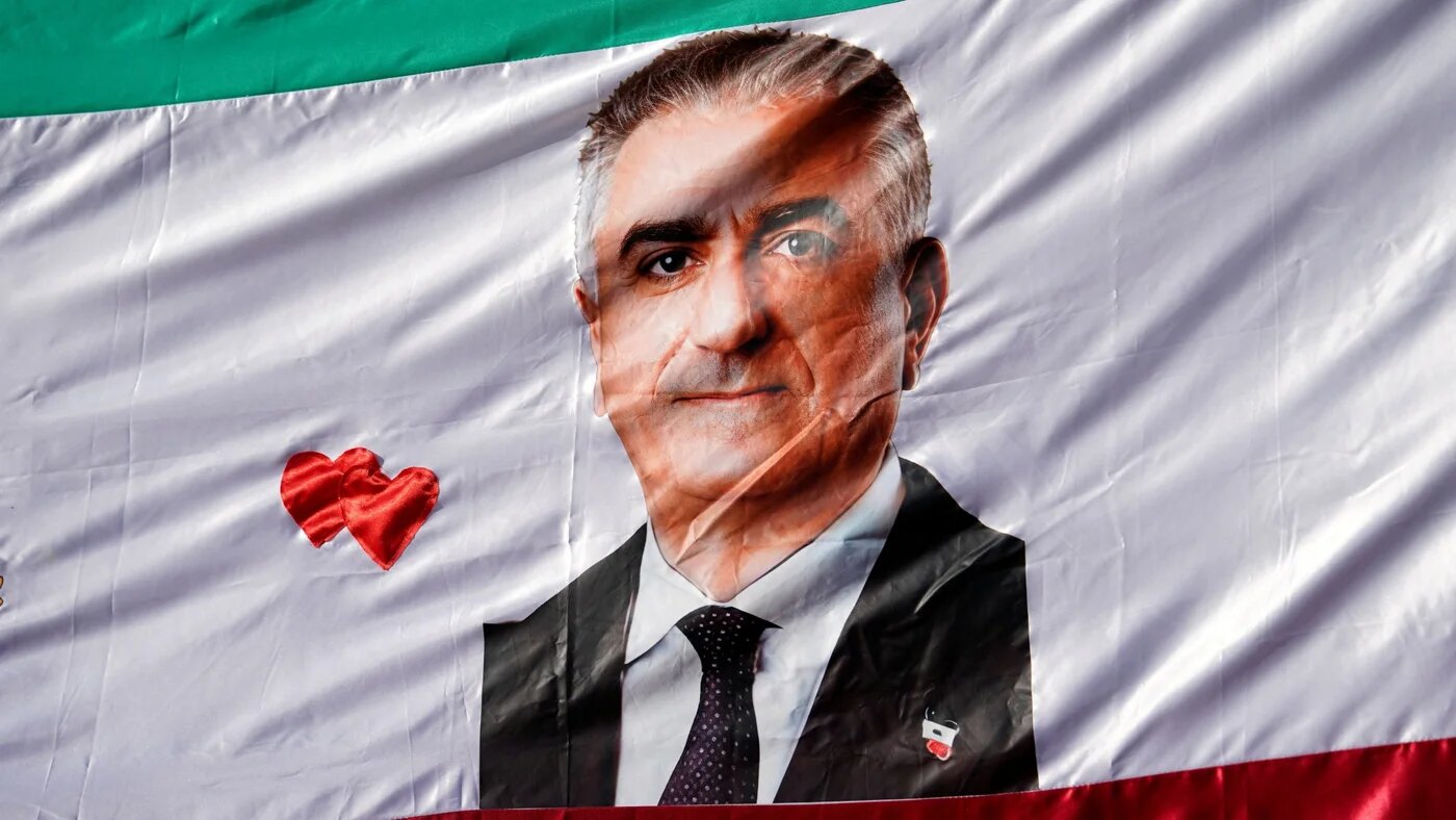 A flag with a picture of Reza Pahlavi is displayed during a protest of the Iranian diaspora following strikes by the US and Israel against Iran, in Madrid, Spain, on 28 February 2026 (Reuters/Ana Beltran)