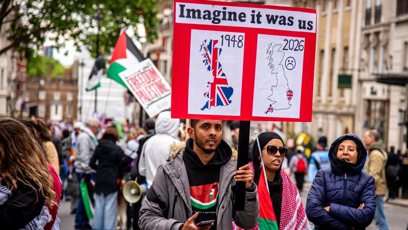 A protester holds a placard during the Nakba 78 march in London on 16 May 2026