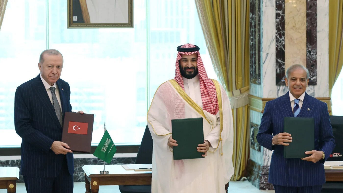 Turkish President Recep Tayyip Erdogan, Saudi Crown Prince Mohammed bin Salman and Pakistan's Prime Minister Shehbaz Sharif pose after signing a joint defence agreement in Mecca, Saudi Arabia, on 7 August 2026