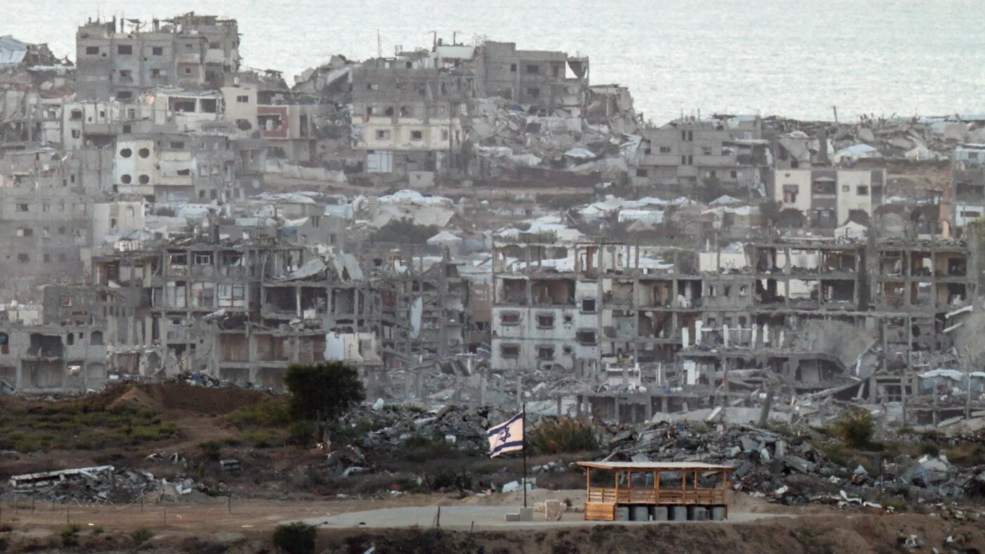 An Israeli flag flutters in Gaza, as seen from the Israeli side of the border, 23 September 2026 (Amir Cohen/Reuters)