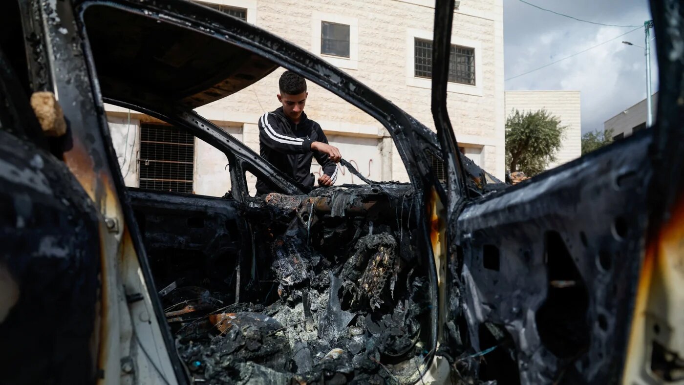 A Palestinian man inspects a vehicle damaged in an Israeli settlers attack, in Al-Mughayyir, near Ramallah, in the occupied West Bank, 29 September 2026 (Mohamad Torokman/Reuters)