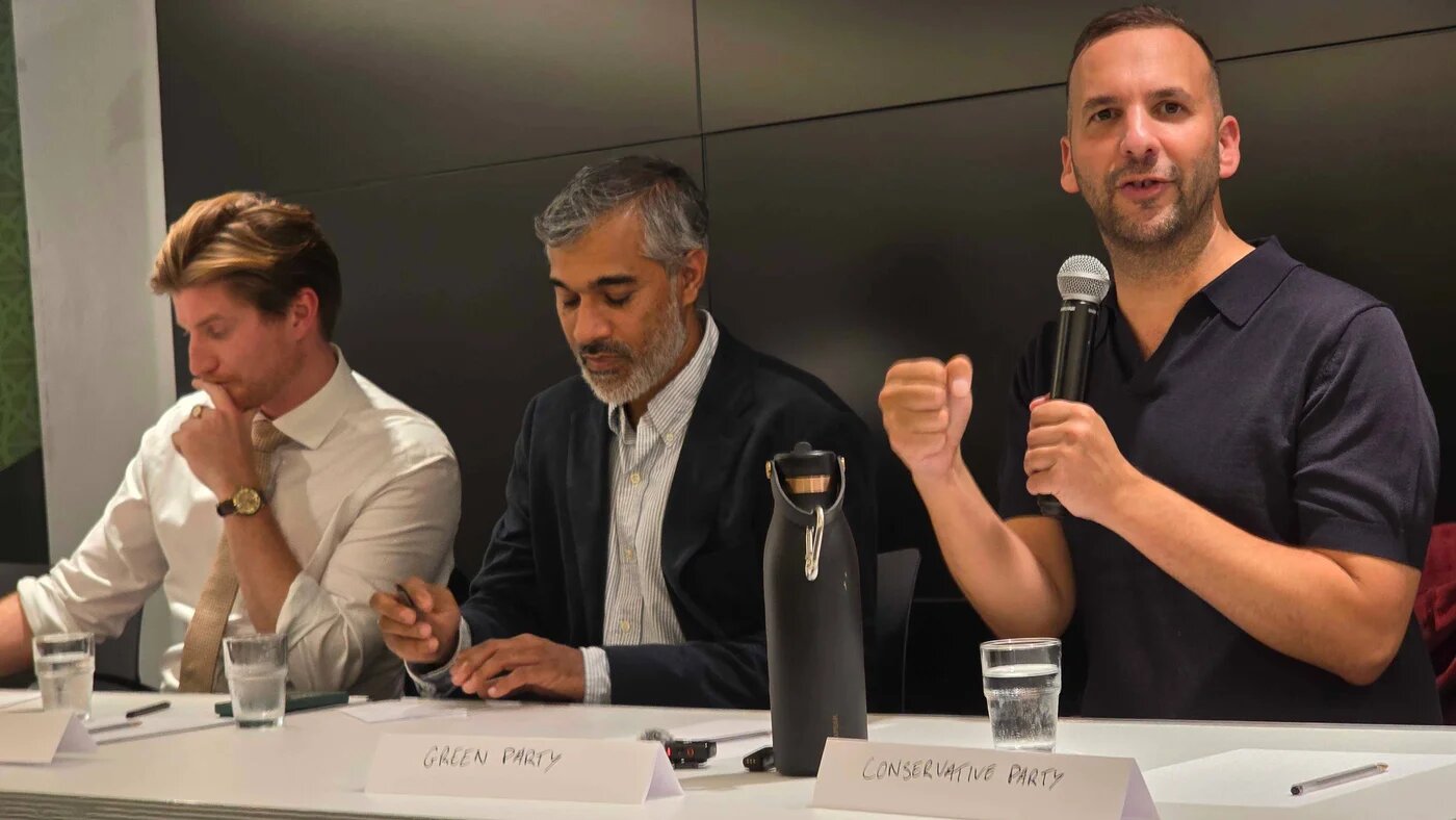 Green Party leader Zack Polanski (R) and Liberal Democrat candidate Patrick Stillman (L) speak at Holborn and St Pancras hustings at the P21 gallery on Tuesday (Imran Mulla/MEE)