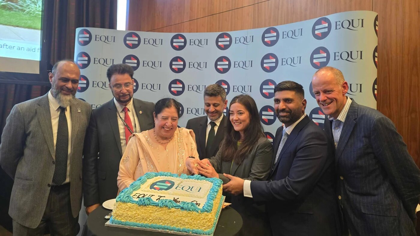 The cake is cut at Equi's reception on Sunday evening at the Labour Party conference in Liverpool. (Imran Mulla/MEE)