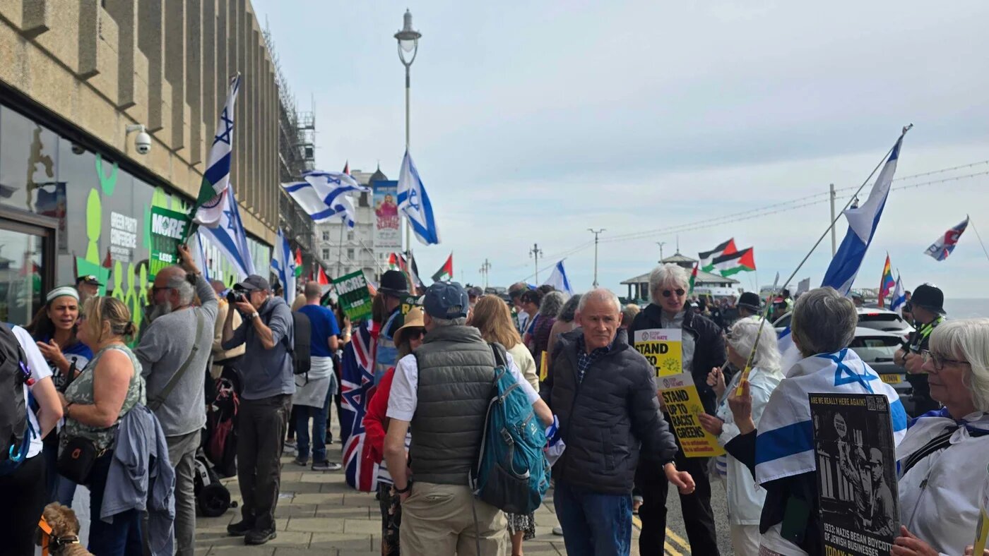 Pro-Israel protesters shout at Green Party members outside the Green conference in Brighton on Saturday. (Imran Mulla/MEE)