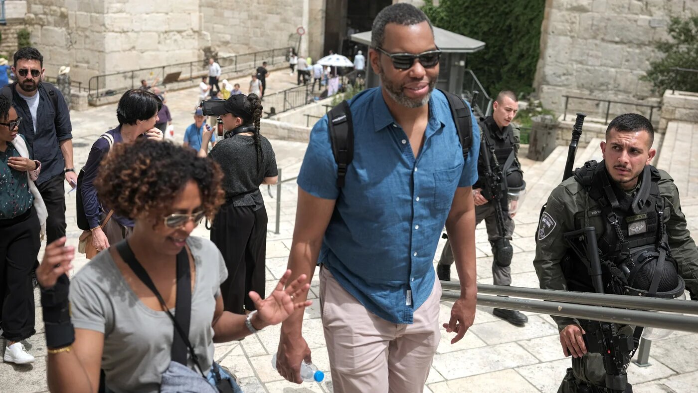 Acclaimed African-American author Ta-Nehisi Coates walks past Israeli soldiers during a visit to the Old City of Jerusalem along with other PalFest participants on 21 May 2023 (Rob Stothard/The Palestine Festival of Literature)