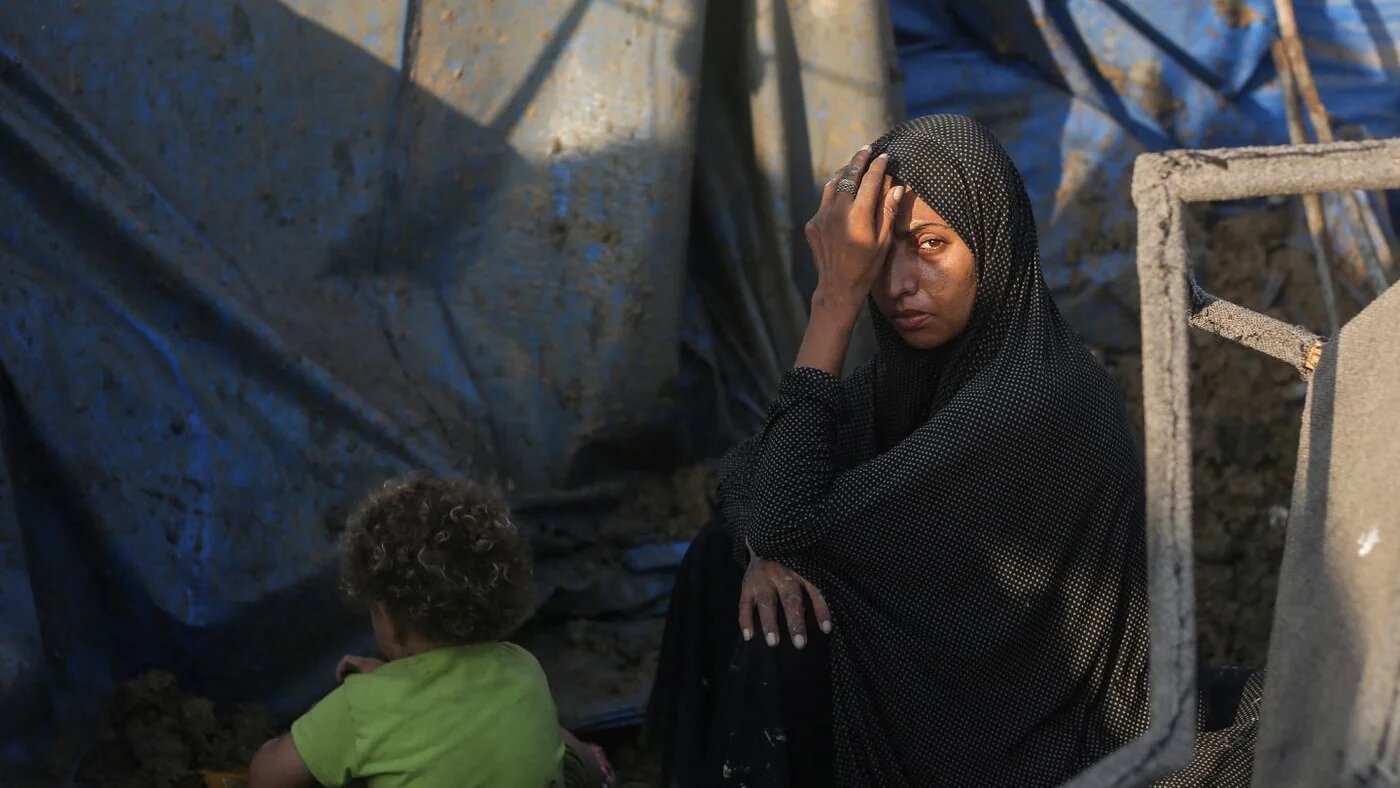 A displaced Palestinian sits outside tents after an Israeli airstrike struck the medical supplies warehouse at Al-Aqsa Martyrs Hospital in Deir al-Balah, central Gaza, 1 August 2026 (Eyad Baba/AFP)