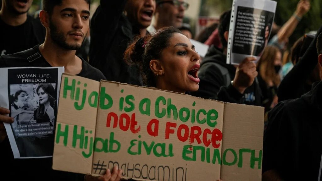 A protester holds a placard during a demonstration by Iranians living in Greece in central Athens on 24 September 2022 (AFP)