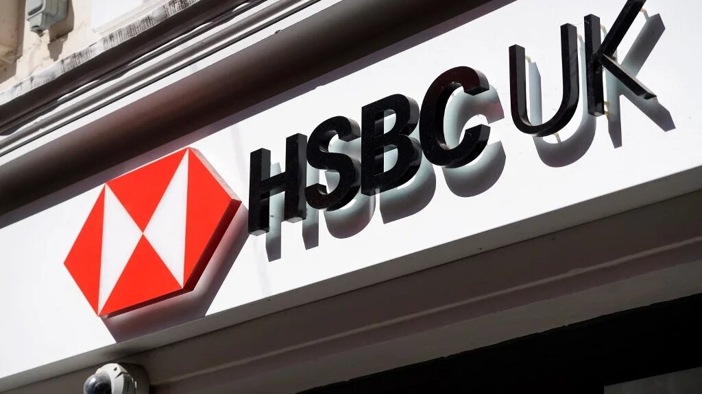 A sign is pictured above a branch of a HSBC bank in central London on April 26, 2022