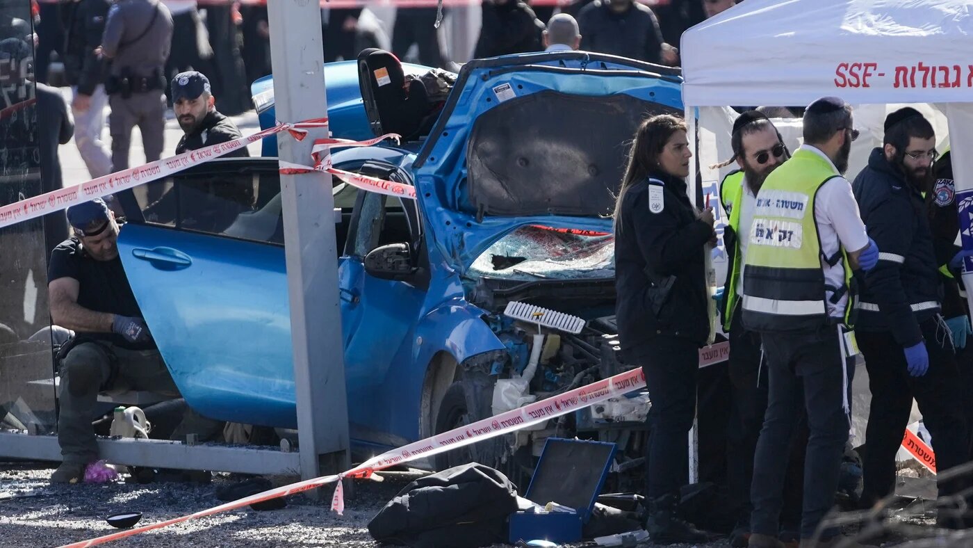Israeli emergency responders work at the site of a car-ramming at a bus stop in occupied East Jerusalem on 10 February 2023 (AP)