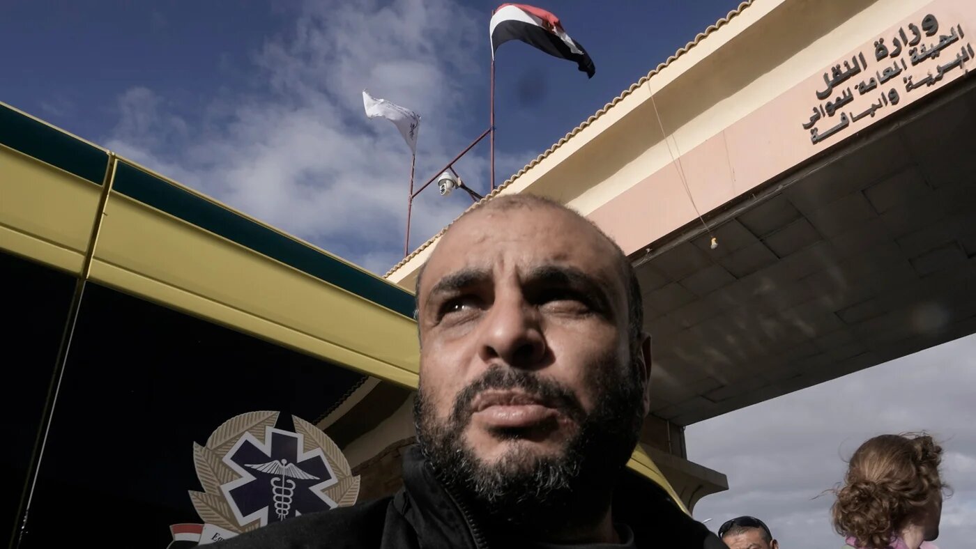 A Palestinian wait at Rafah crossing to to enter the Gaza Strip from Egypt on 27 November 2023 (AP)
