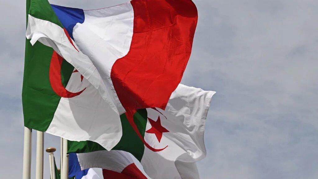 The Algerian and French flags sway in Algiers as French PM arrives for two-day official visit on 9 October 2022 (Alain Jocard/AFP)