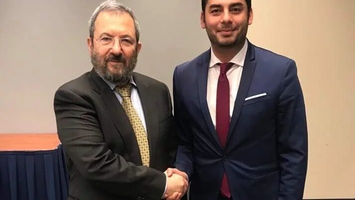 Ammar Campa-Najjar shaking hands with former Israeli Prime Minister Ehud Barak
