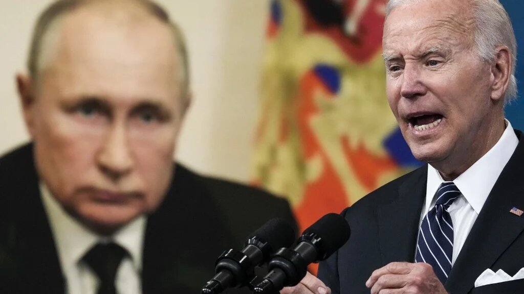 An image of Russian President Vladimir Putin behind US President Joe Biden as he speaks about gas prices at the White House on 22 June 2022 (AFP)