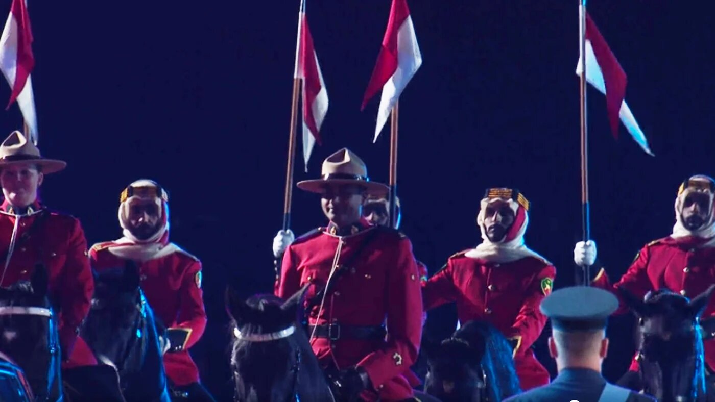A lightened screengrab from ITV's televised broadcast of the Royal Windsor Horse Show showing Bahraini Defense Forces escorting the Queen (ITV)