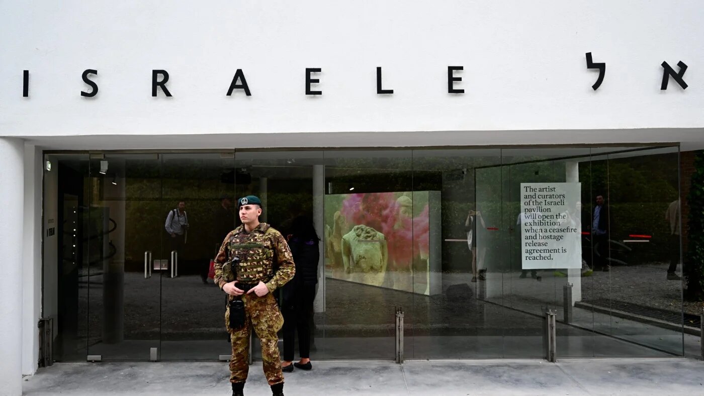 An Italian soldier stands guard in front of Israel's pavilion during the pre-opening of the Venice Biennale art show, on 16 April 2024 (AFP)