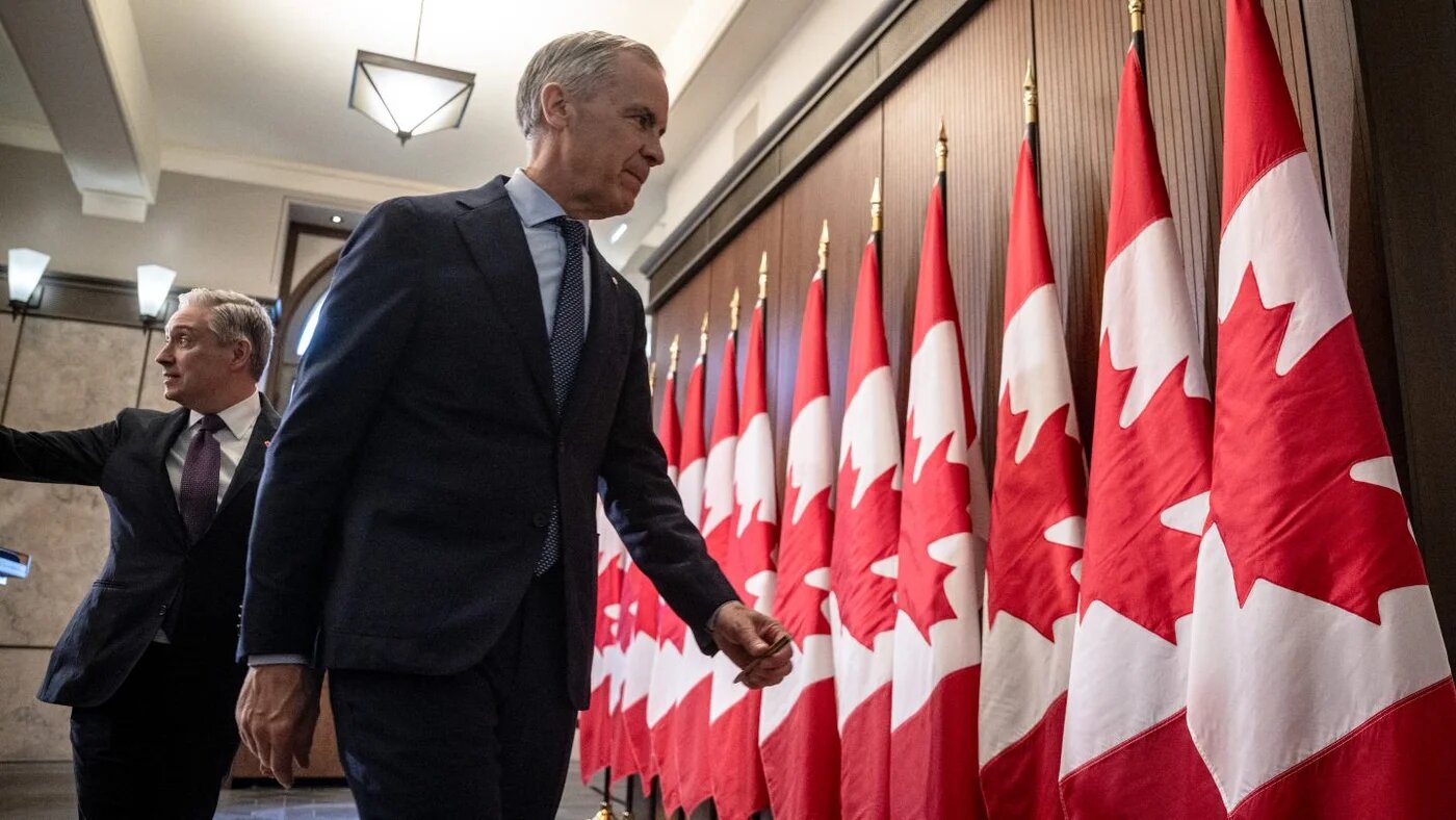 Canadian Prime Minister Mark Carney and Finance Minister Francois-Philippe Champagne leave a press conference on Parliament Hill in Ottawa, 14 April 2026 (Andrèj Ivanov/AFP)