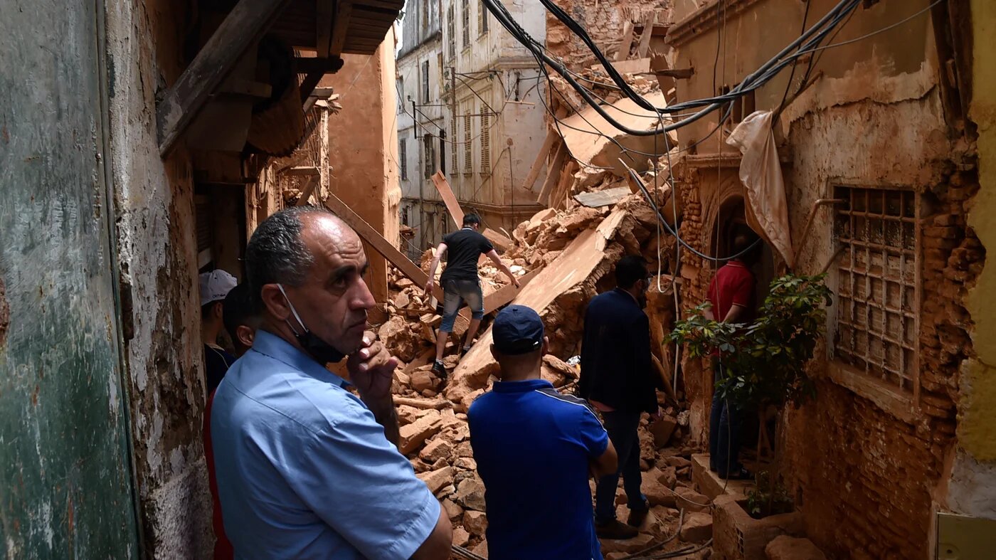 Des habitants de la Casbah regardent un immeuble qui s’est effondré, le 6 juin 2020 (AFP/Ryad Kramdi)