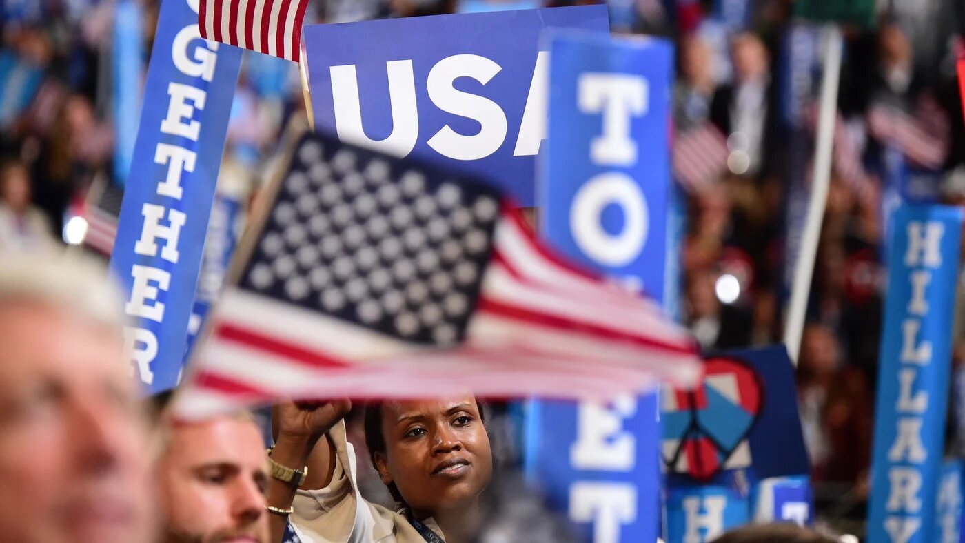 A woman waves a flag at the Democratic National Convention