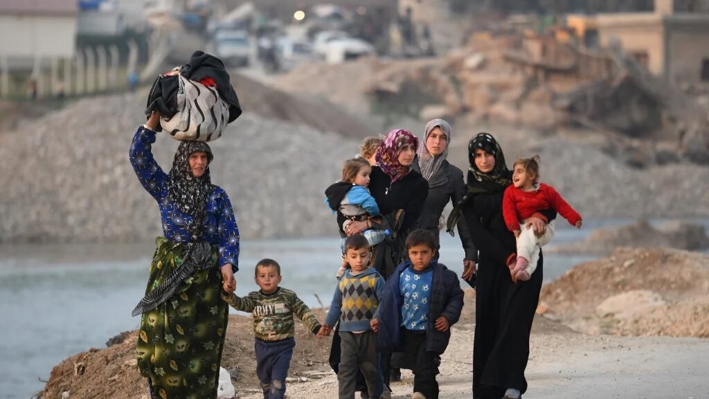 Displaced Syrians arrive at Deir al-Ballut camp in Afrin's countryside, near the border with Turkey