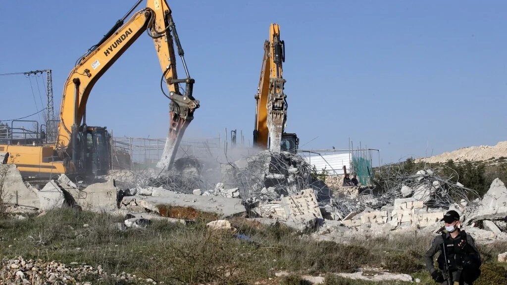 Israeli excavators demolish a Palestinian house in the southern outskirts of Hebron in the occupied West Bank on 3 February (AFP/File photo)