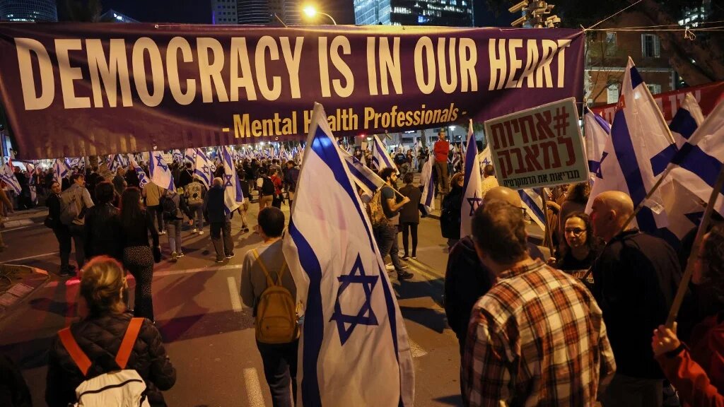 Demonstrators attend a protest against the Israeli government's controversial judicial reform bill in Tel Aviv on 11 March 2023 (AFP)