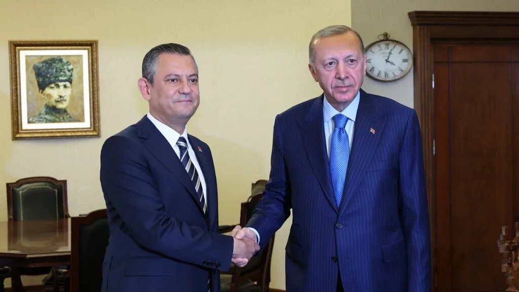 This handout photograph taken and released by the Turkish Presidency Press Service on June 11, 2024 shows then-Leader of the Republican People's Party (CHP) Ozgur Ozel (L) and Turkish President Recep Tayyip Erdogan (R) shaking hands at the CHP Headquarters during their meeting in Ankara. (AFP)